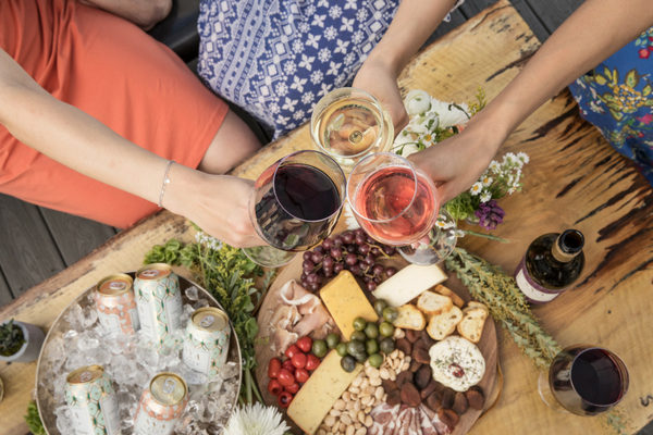 Guests cheersing wine glasses at a dinner party