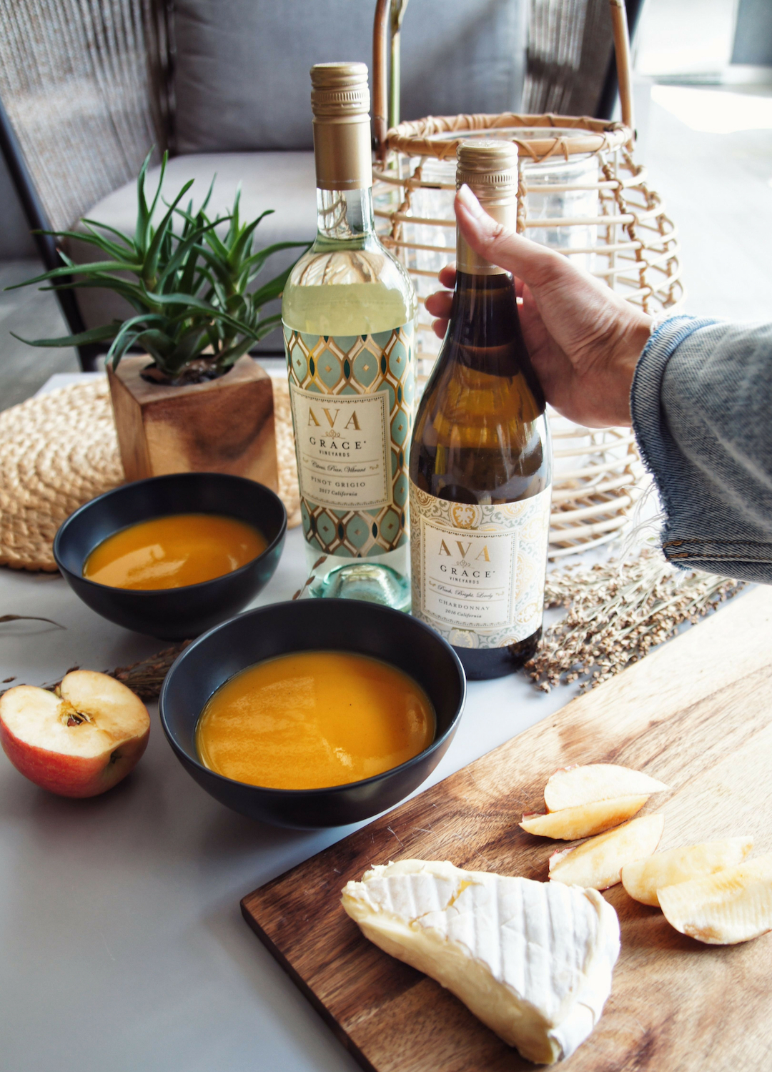 Soup, cheese, and AVA Grace wines on a table
