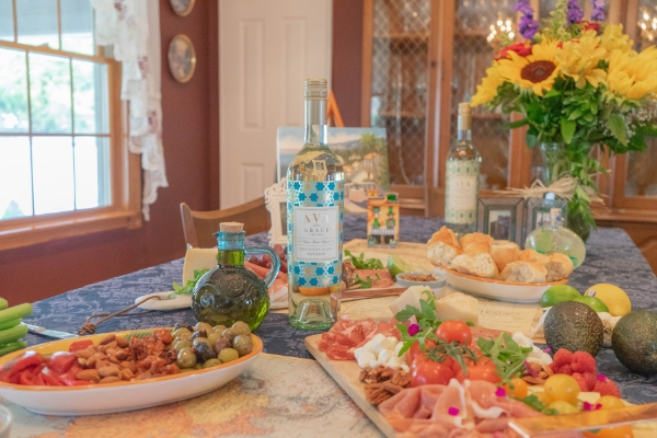 AVA Grace Sauvignon Blanc on a table with food for a welcome home party