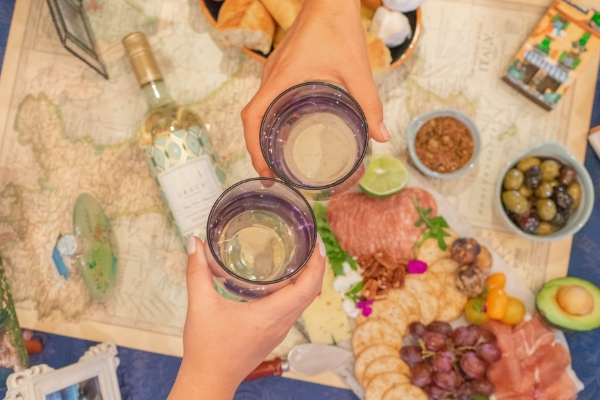 Cheersing with wine at a welcome home party