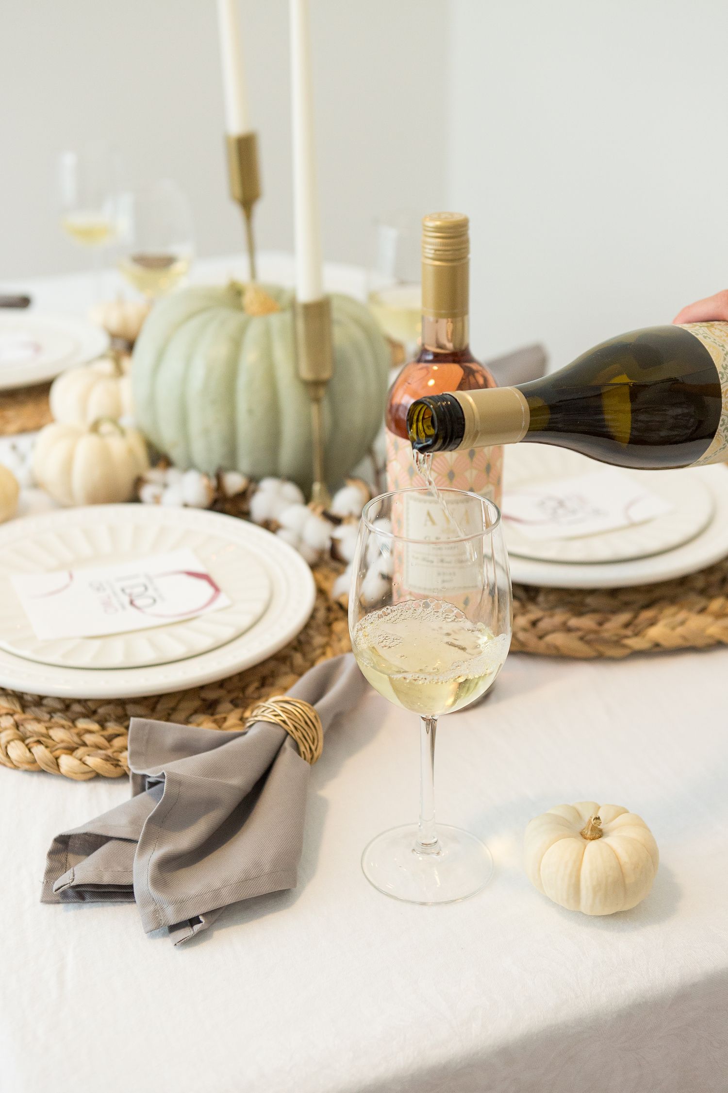 AVA Grace Chardonnay poured into a wine glass with a fall themed table in the background