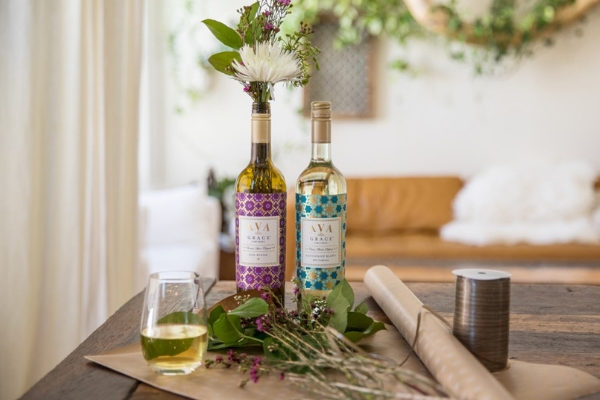 Reuse empty wine bottles as flower vases as a rainy day activity for adults