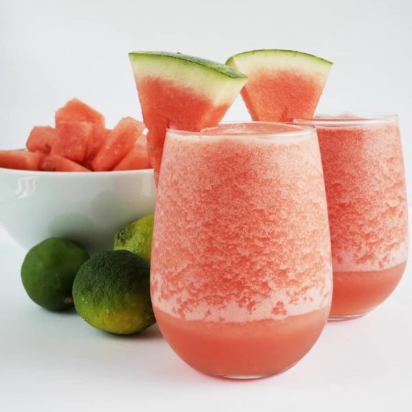 Frosé glasses next to fresh watermelon