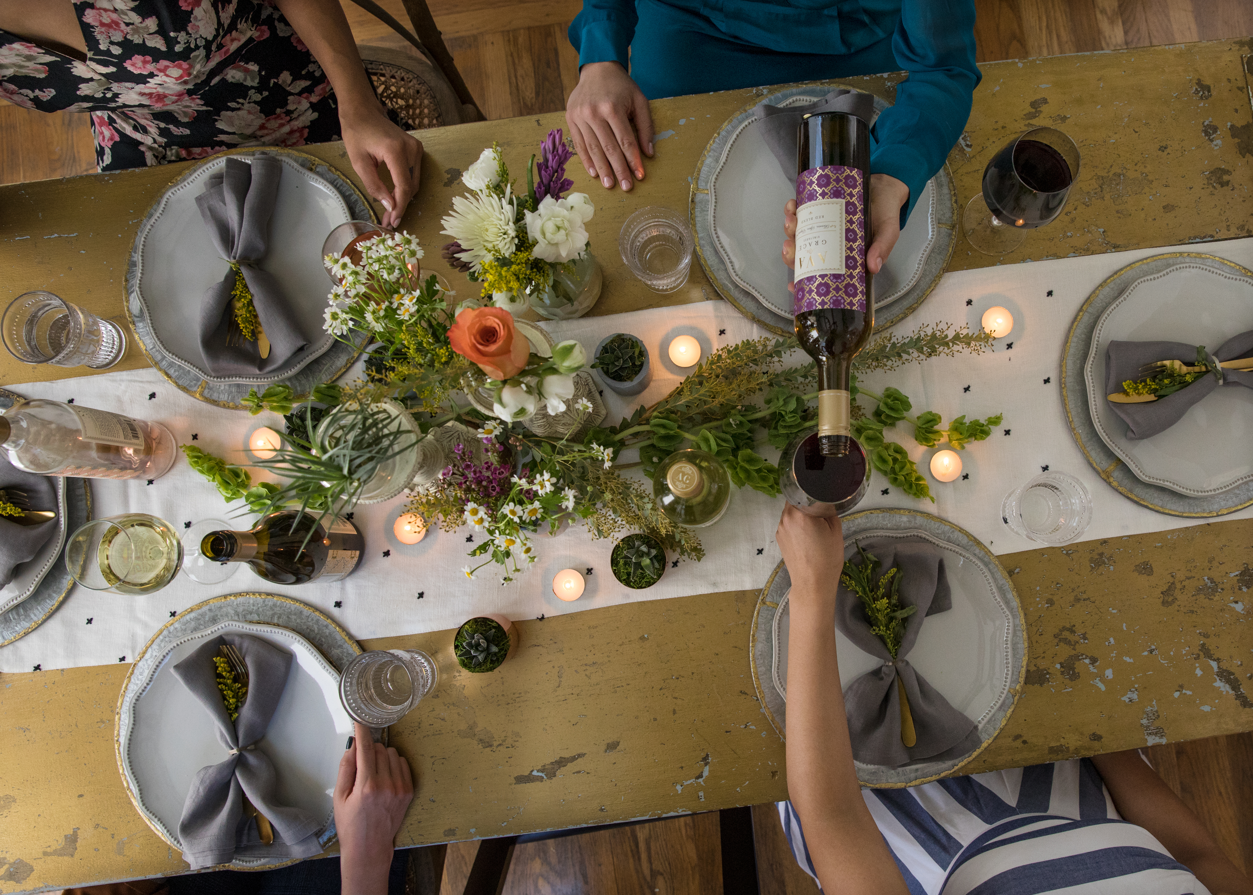 Someone pouring AVA Grace wine on a Thanksgiving Table