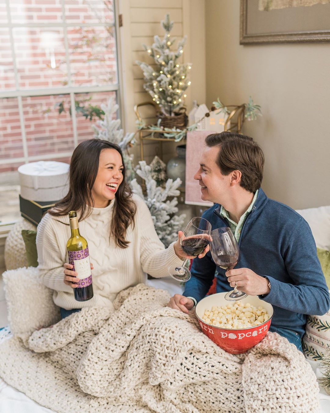 Couple drinking AVA Grace at their holiday gift exchange