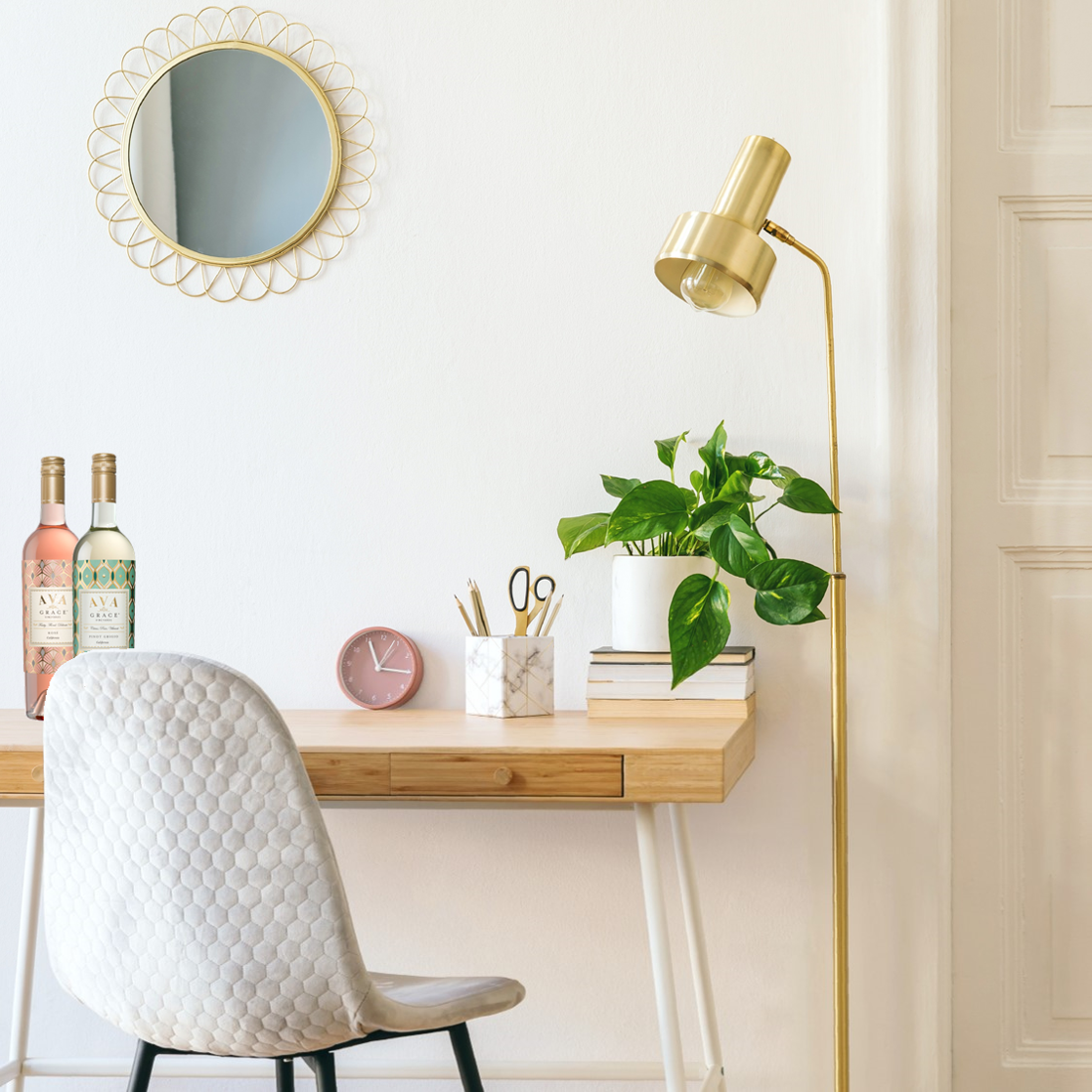 The perfect work from home space with two bottle of AVA Grace wines on the desk.
